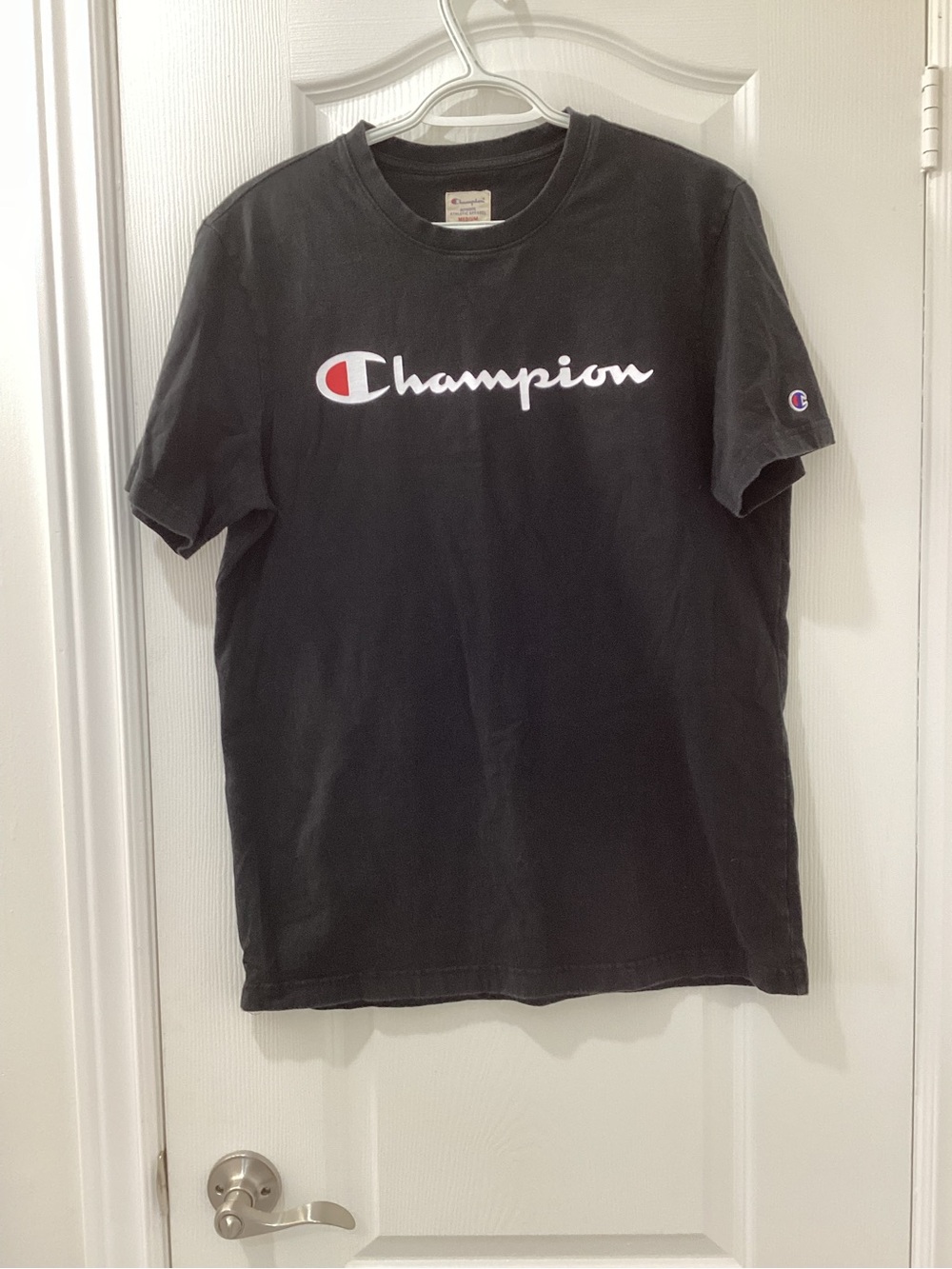 Champion Black Short Sleeve Tee with White Script Logo and Red Accent